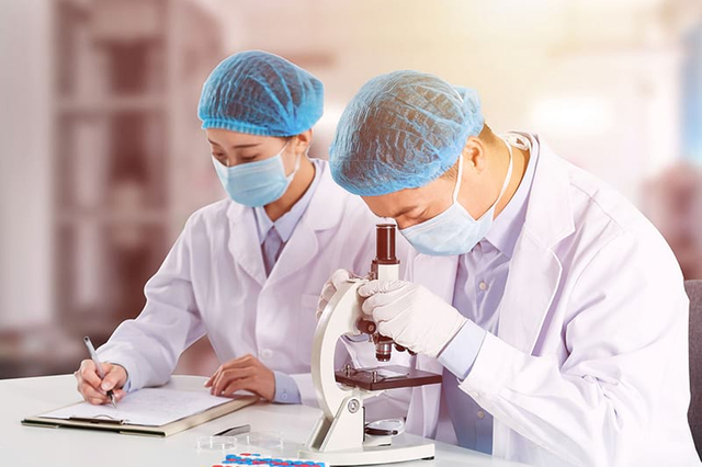 Lab technicians testing toothpaste tablet and mouth spray formulas